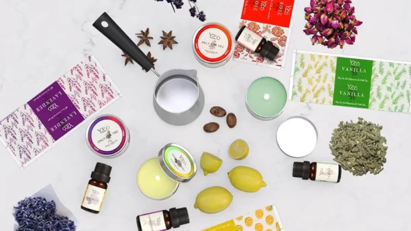 A full candle making kit featuring soy wax bags, metal tins, colorful dyes, wicks, fragrance oils, and crafting tools neatly arranged on a table — ideal for DIY candle lovers.