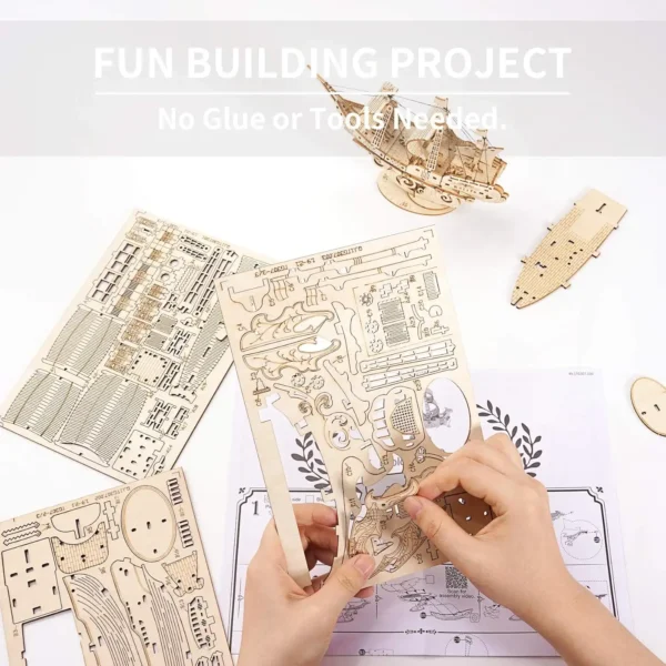 Hands assembling the wooden ship puzzle by popping out pieces from laser-cut sheets.