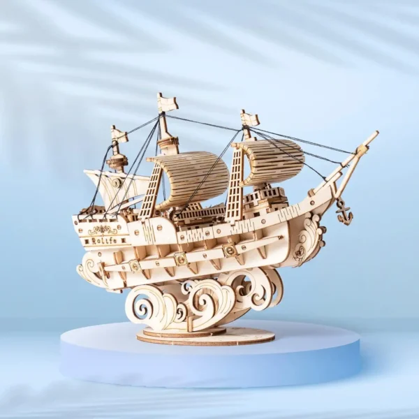 Fully assembled 3D wooden sailing ship model displayed on a round pedestal.