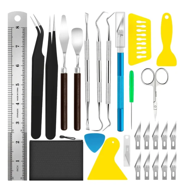 Close-up of a polymer clay toolkit with sculpting tools, cutting mat, ruler, tweezers, and precision blades.